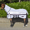 Horse wearing a white fly sheet with black straps in front of green bushes.
